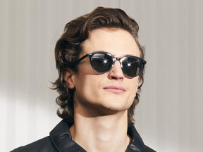 Model is wearing The KITZEL SUN in Ink in size 50 with G-15 Glass Lenses