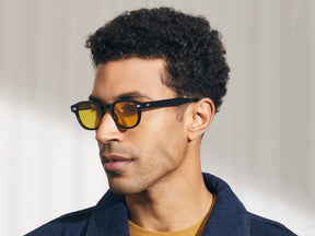 Model is wearing The LEMTOSH in Black in size 46 with Mellow Yellow Tinted Lenses