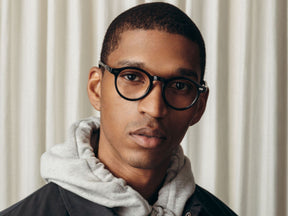 Model is wearing The MILTZEN in Black in size 46 with Blue Protect Lenses