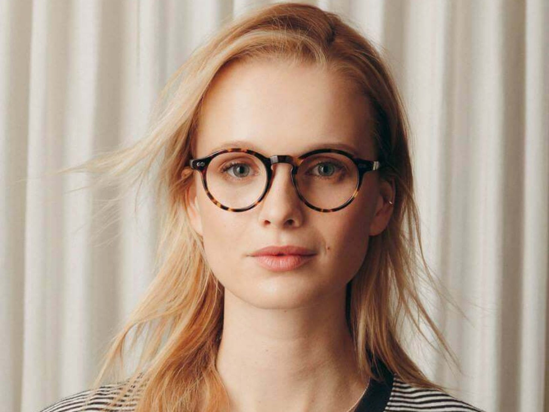 Model is wearing The MILTZEN in Classic Havana in size 49 with Blue Protect Lenses