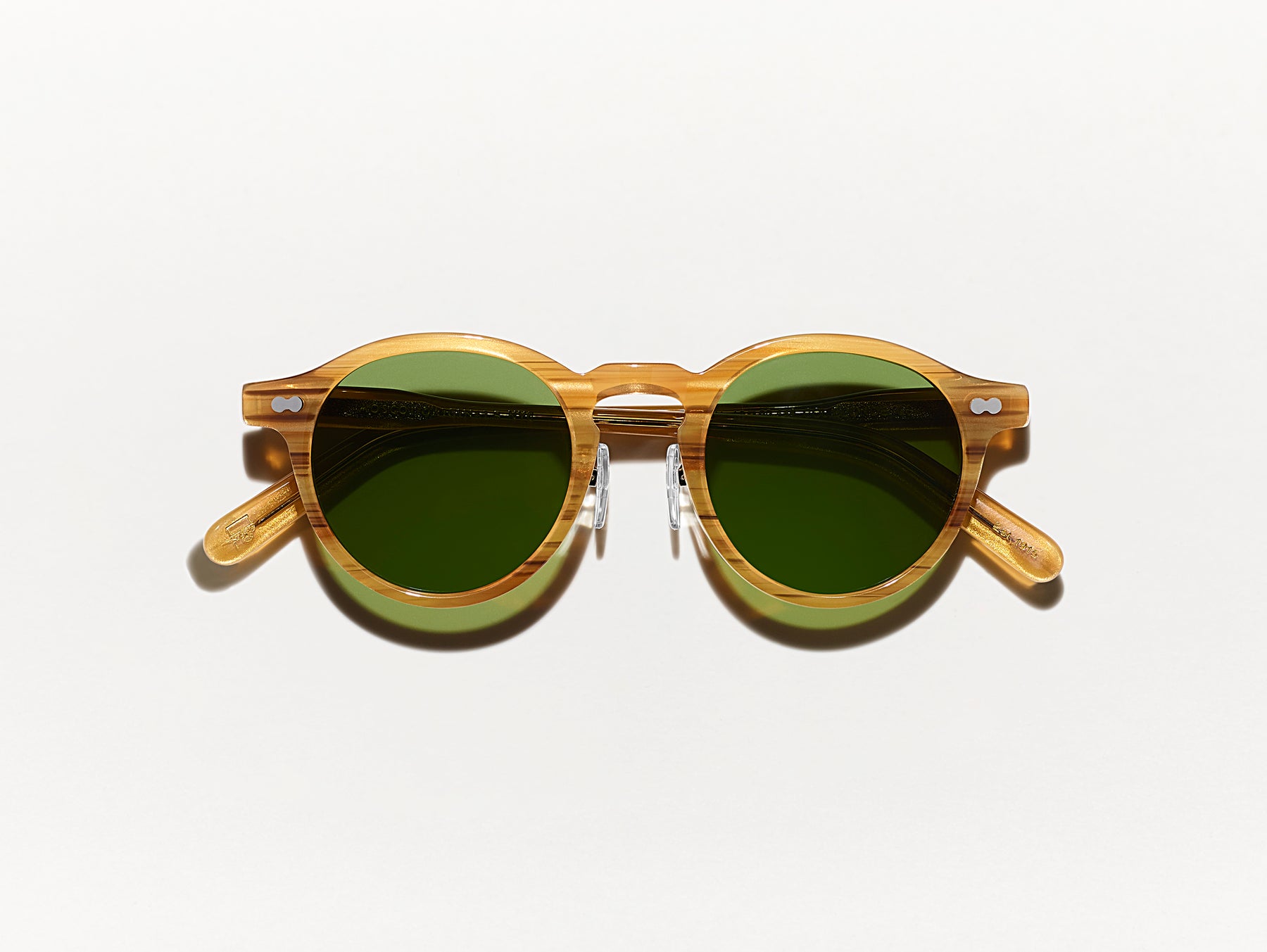 The MILTZEN SUN W/ METAL NOSE PADS in Blonde with Calibar Green Glass Lenses