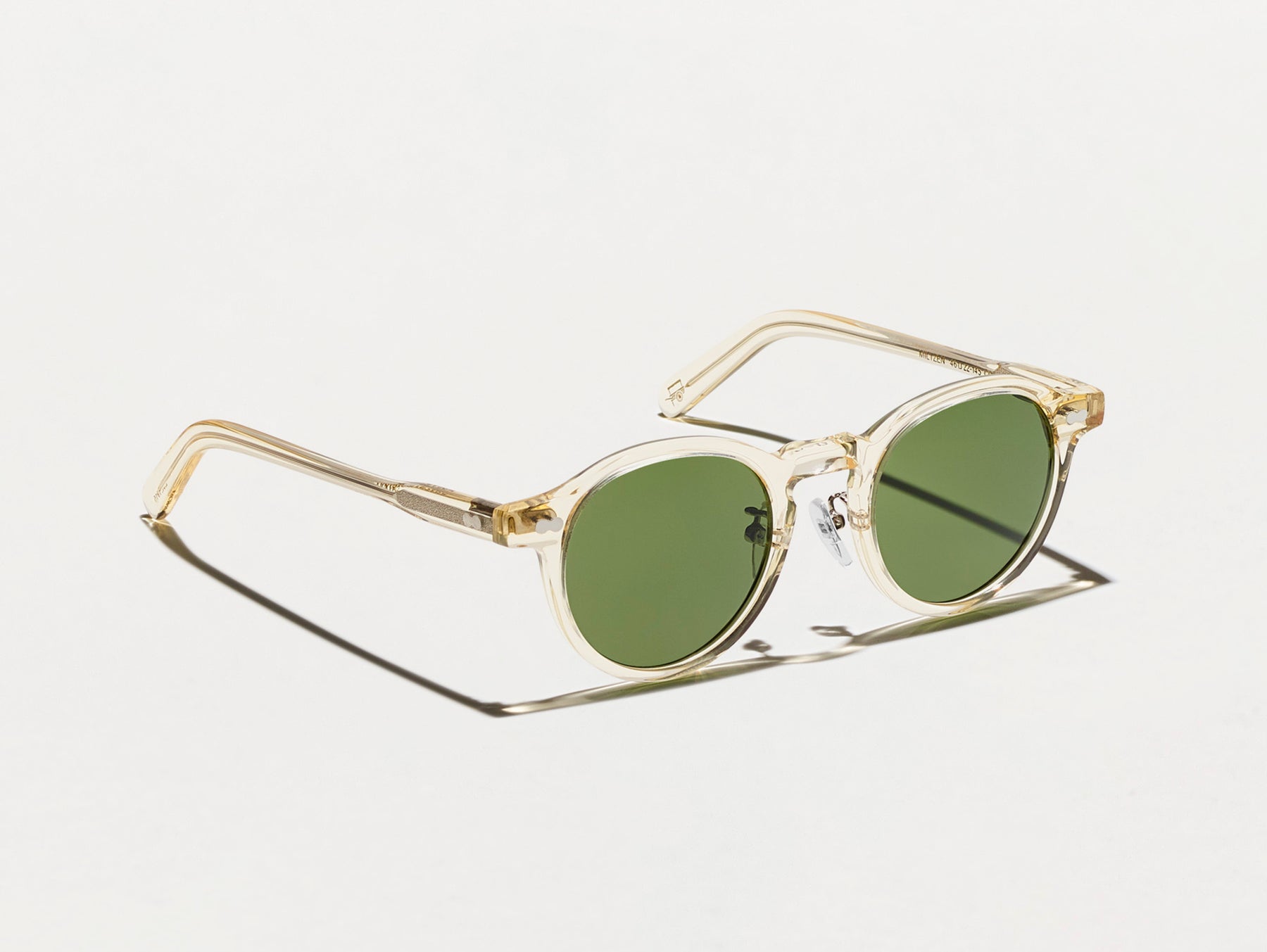 The MILTZEN SUN W/ METAL NOSE PADS in Flesh with Calibar Green Glass Lenses