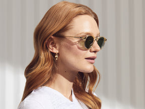 Model is wearing The MILTZEN SUN W/ METAL NOSE PADS in Flesh in size 49 with Calibar Green Glass Lenses