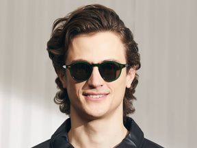 Model is wearing The MILTZEN SUN in Emerald in size 46 with Grey Glass Lenses