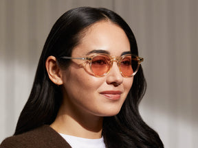 Model is wearing The MILTZEN in Flesh in size 46 with New York Rose Tinted Lenses