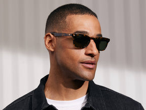 Model is wearing The MOBBLE SUN in Tortoise in size 53 with G-15 Glass Lenses