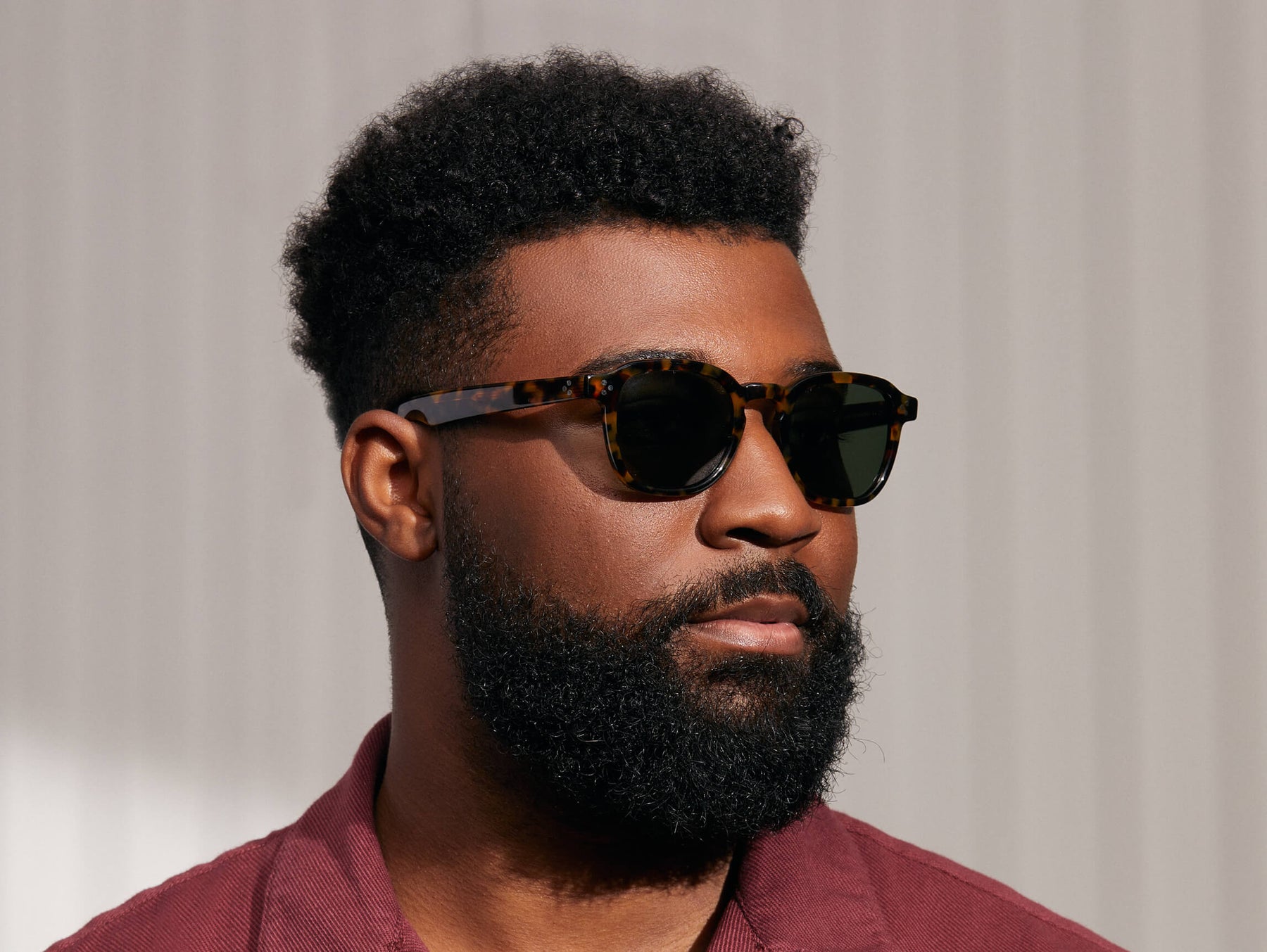 Model is wearing The MOMZA SUN in Tortoise in size 49 with G-15 Glass Lenses