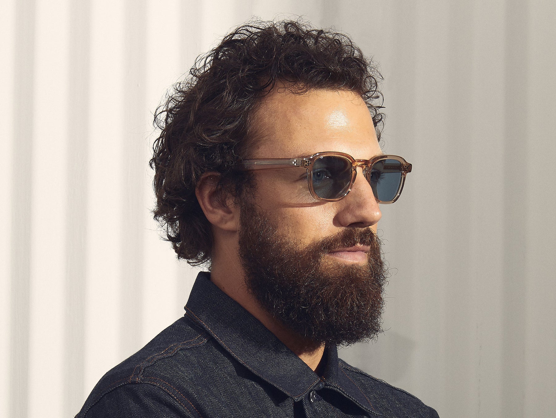 Model is wearing The MOMZA SUN in Cinnamon in size 49 with Blue Glass Lenses