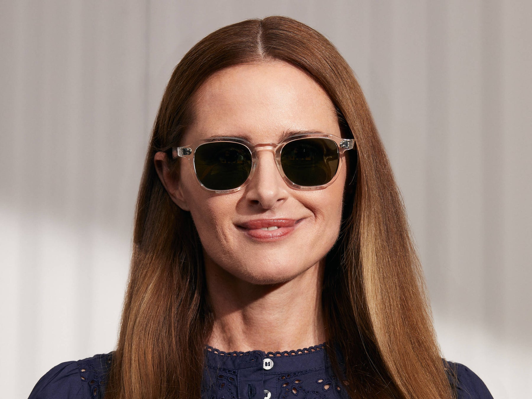 Model is wearing The MOMZA SUN in Crystal in size 49 with G-15 Glass Lenses