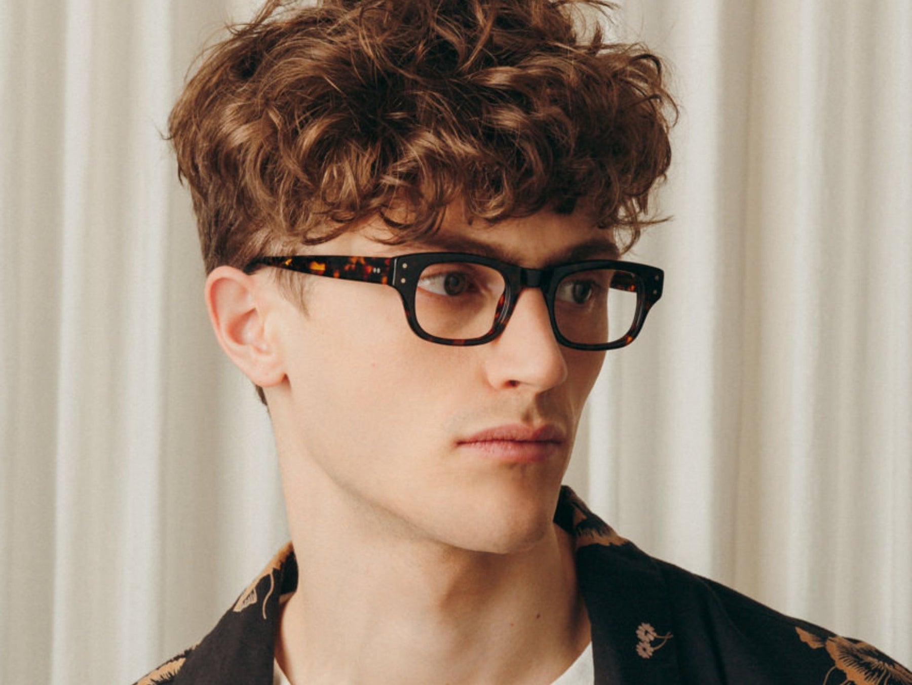 Model is wearing The NEBB in Tortoise in size 48 with Blue Protect Lenses