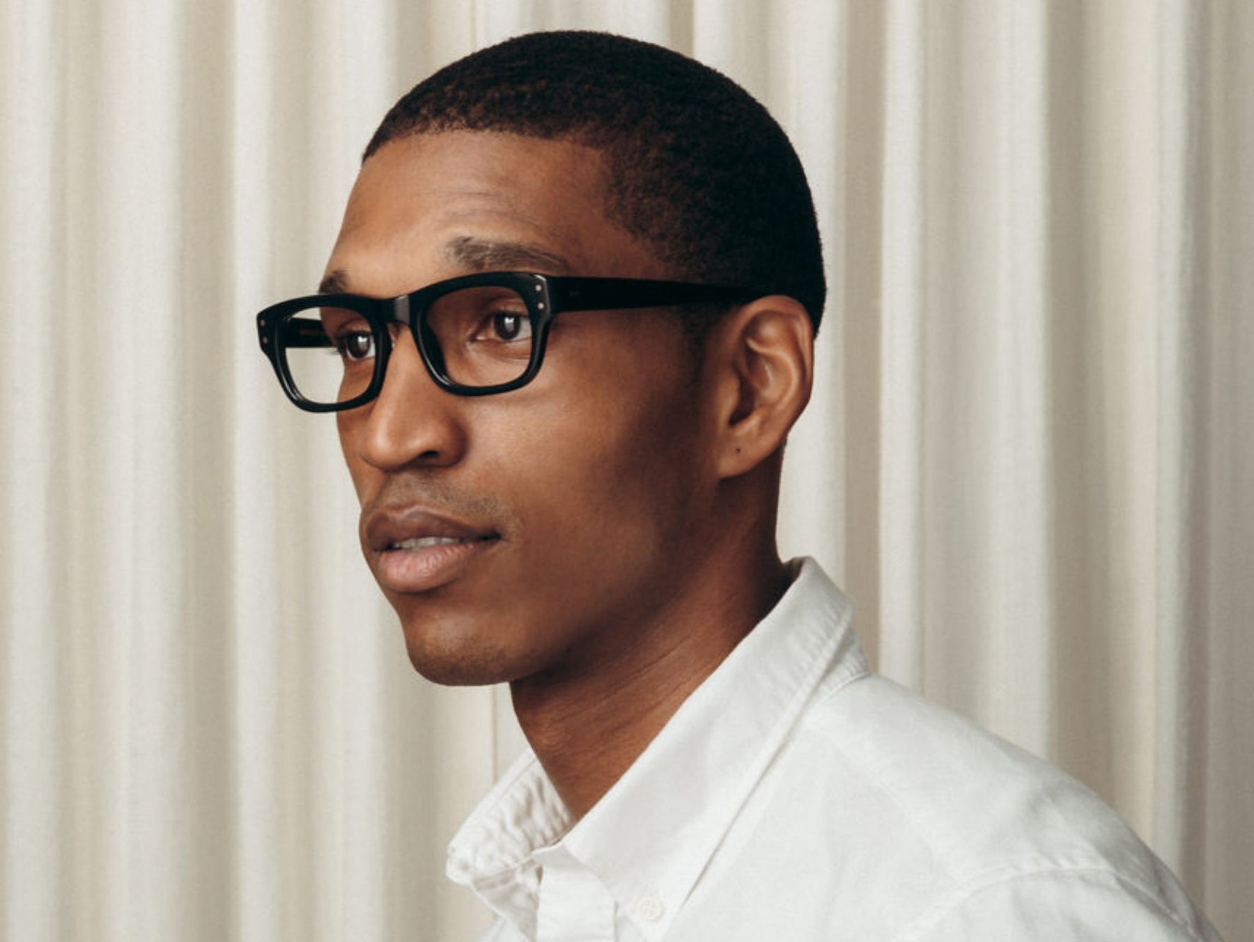 Model is wearing The NEBB in Matte Black in size 48 with Blue Protect Lenses