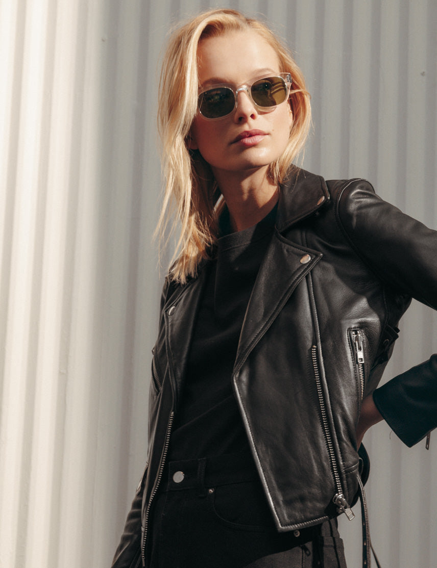 Model is wearing The NEBB SUN in Crystal in size 51 with Calibar Green Glass Lenses