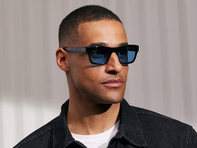 Model is wearing The NUDNIK SUN in Black in size 50 with Celebrity Tinted Lenses