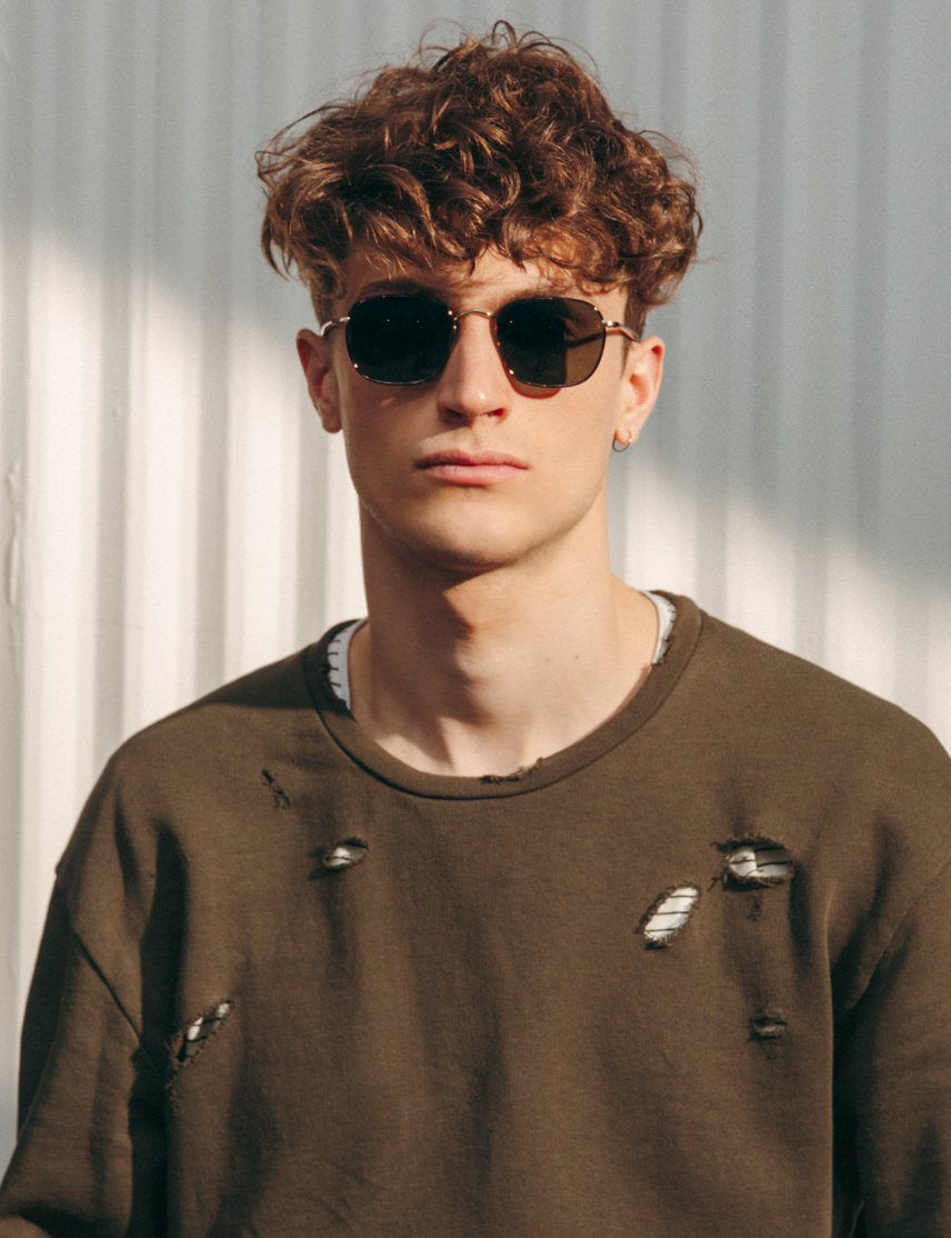 Model is wearing The SCHLEP SUN in Tortoise/Gold in size 50 with G-15 Glass Lenses