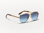 The SHAV SUN in Gold with Denim Blue Tinted Lenses