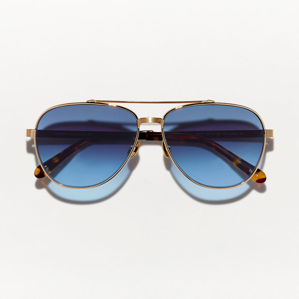 #color_denim blue | The SHAV SUN in Gold with Denim Blue Tinted Lenses