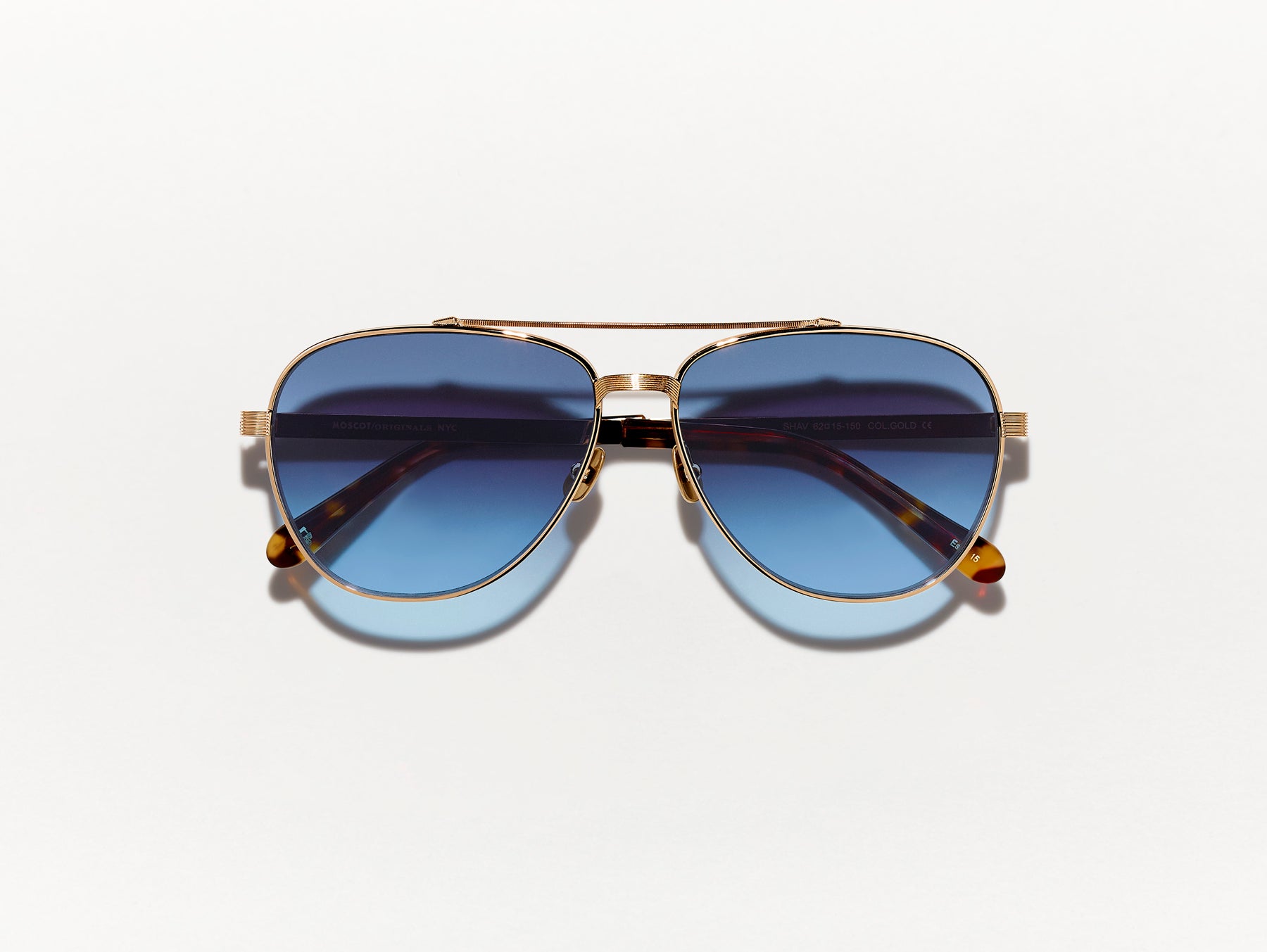 The SHAV SUN in Gold with Denim Blue Tinted Lenses