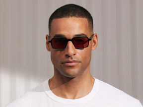 Model is wearing The SHINDIG Black in size 50 with Purple Nurple Tinted Lenses