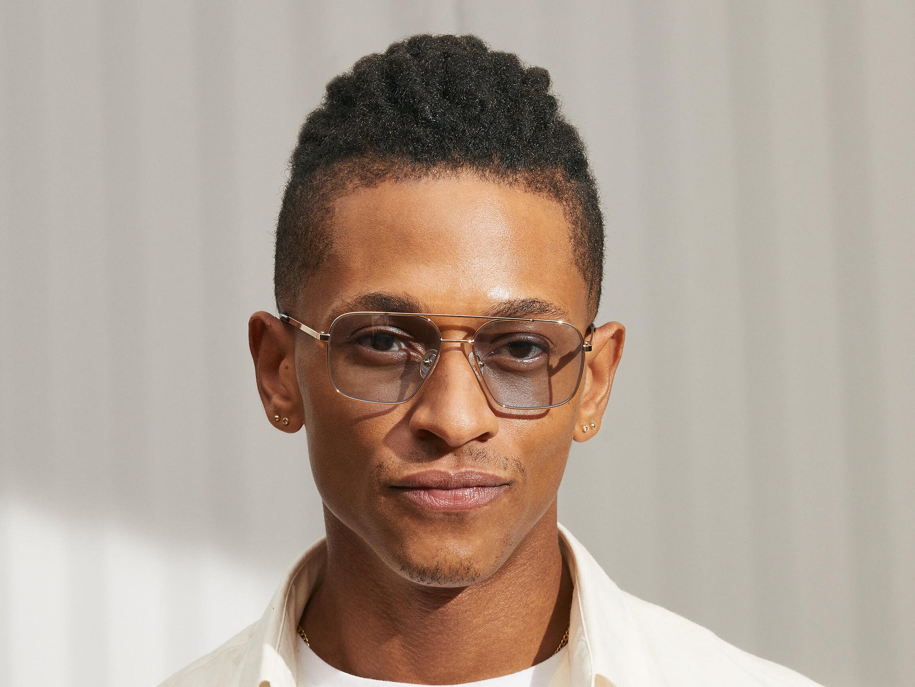 Model is wearing The SHTARKER in size 54 in Gold with Bel Air Blue Tinted Lenses