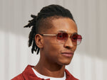 Model is wearing The SHTARKER in size 54 in Gold with Big Apple Fade Tinted Lenses