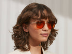 Model is wearing The SHTARKER in size 54 in Gold with Woodstock Orange Tinted Lenses