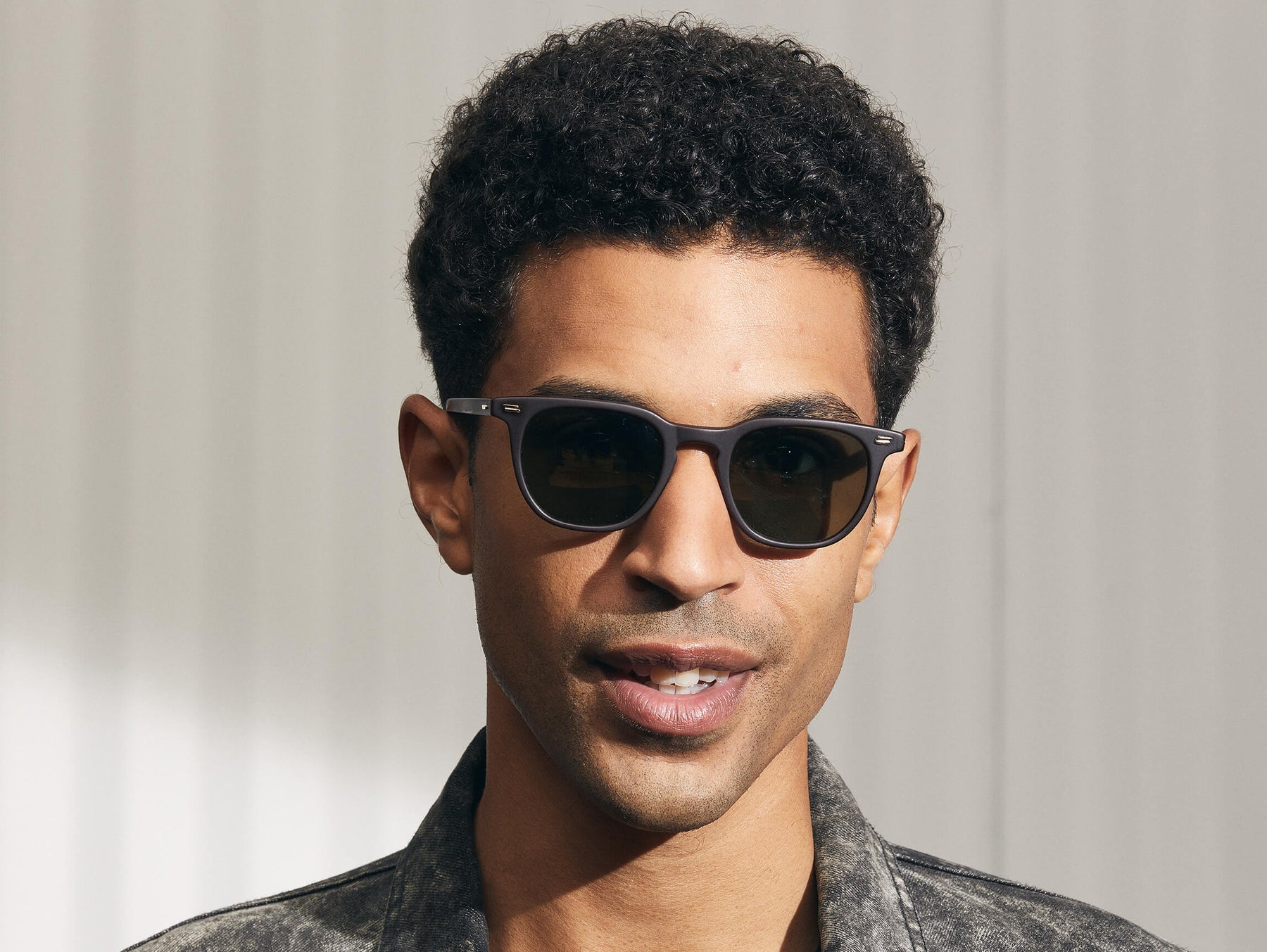 Model is wearing The TATAH SUN in Matte Dark Brown in size 50 with G-15 Glass Lenses