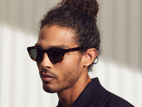 Model is wearing the TELENA SUN in Cinnamon/Flesh in size 44 with Calibar Green Glass Lenses