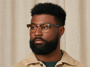 Model is wearing The TINIF in size 48 in Tortoise/Gold