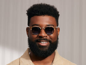 Model is wearing The TINIF SUN in Cinnamon/Gold in size 48 with Denim Blue Tinted Lenses