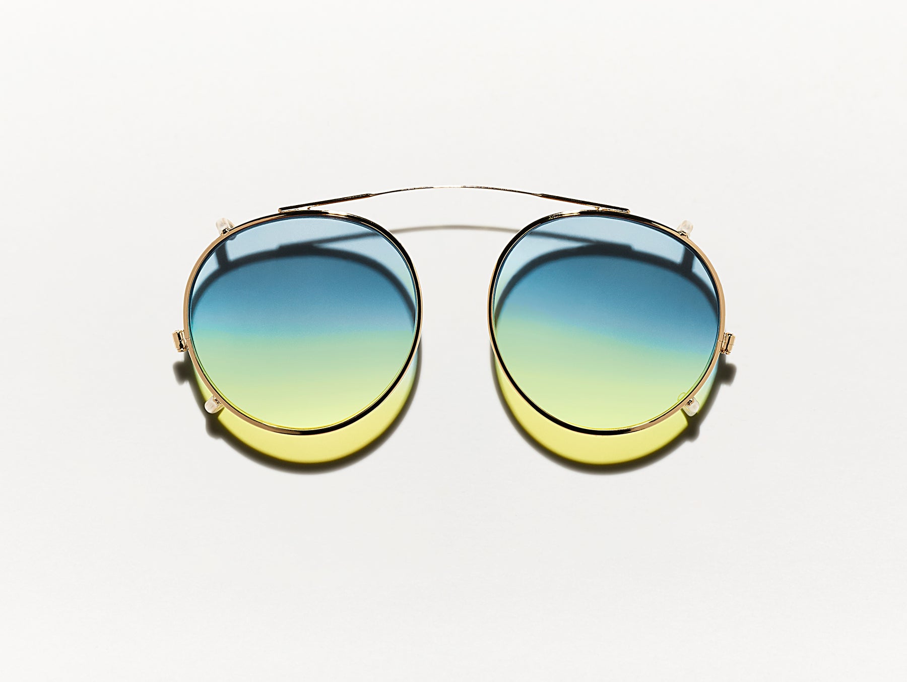 The CLIPZEN in Gold with Aqua Sunrise Tinted Lenses