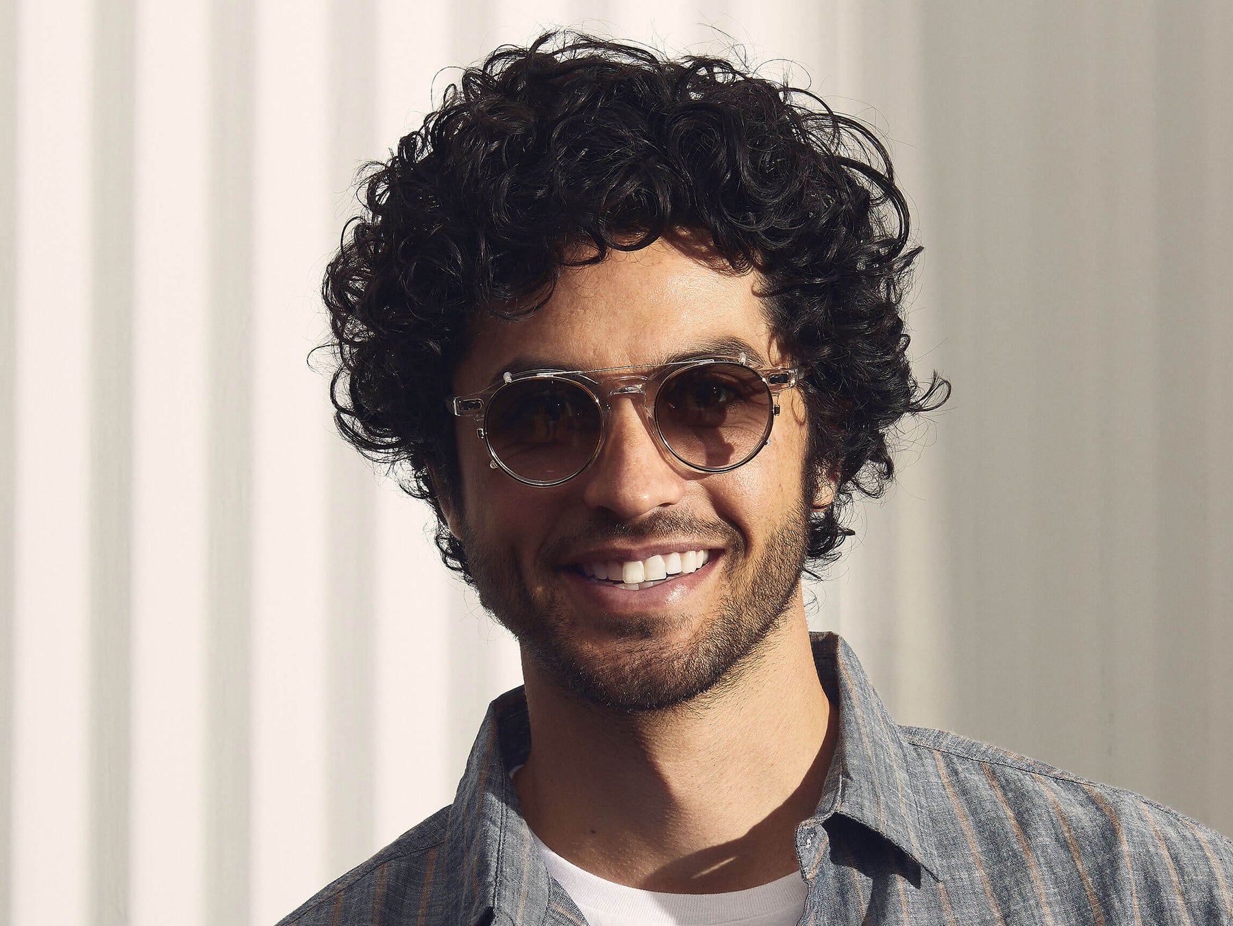 Model is wearing The CLIPZEN in Gold in size 49 with G-15 Fade Tinted Lenses