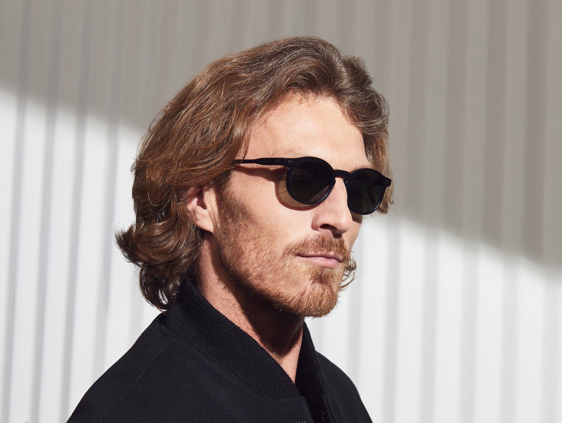 Model is wearing The VELVYL SUN in Black size 46 with G-15 Glass Lenses