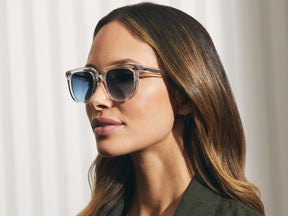 Model is wearing The YONTIF SUN in Crystal in size 52 with Denim Blue Tinted Lenses