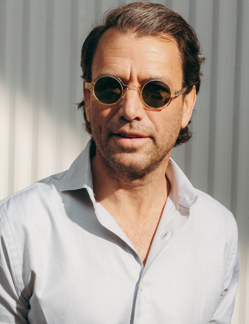 Model is wearing The ZOLMAN SUN in Flesh in size 42 with Calibar Green Glass Lenses