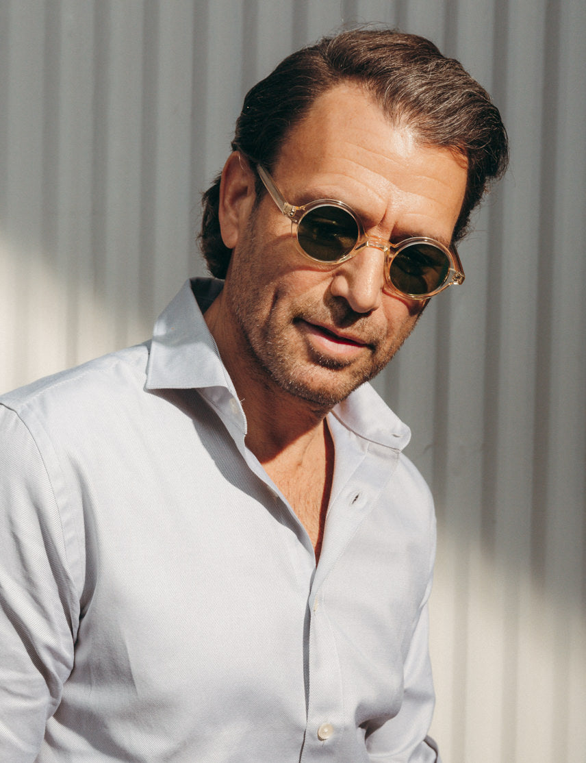 Model is wearing The ZOLMAN SUN in Flesh in size 42 with Calibar Green Glass Lenses